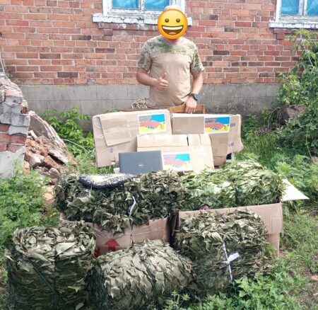 A fighter with camouflage nets and aid packages delivered thanks to Grandpa Borys and the FST volunteer group.
